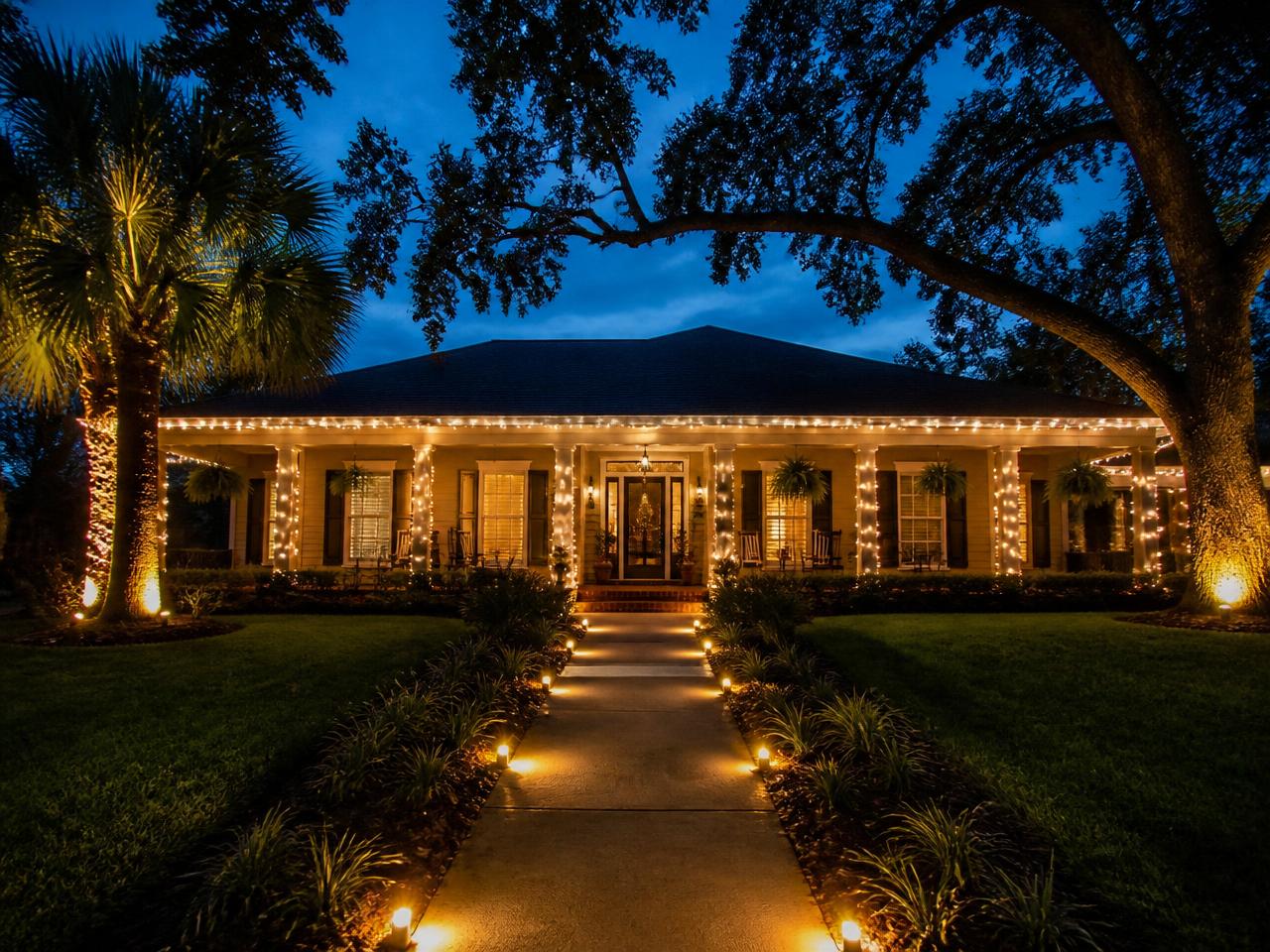 Ranch-style Louisiana home with wrapped porch posts and a lighted walkway
